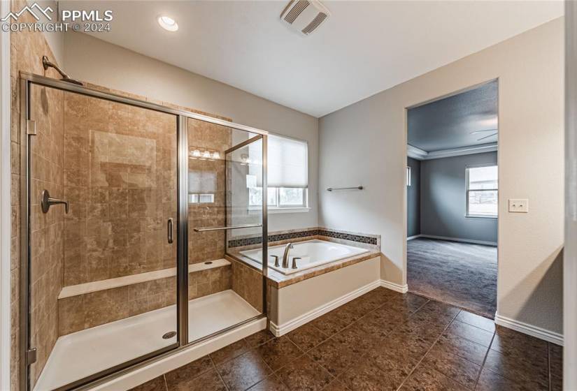 Bathroom featuring ornamental molding, separate shower and tub, and tile floors