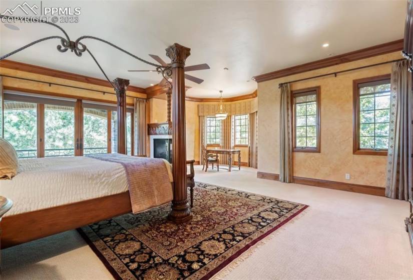 Expansive primary bedroom with office area and two fireplaces