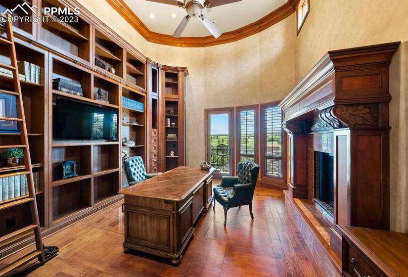 Gorgeous office that also enjoys access to the massive outdoor deck and is fully equipped with custom bookcases and a fireplace for extra ambience