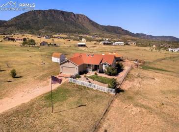 This stunning ranch-style home sits on over 5 acres of land.  Offering mountain & city views.