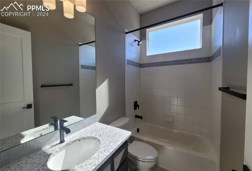 Full Bathroom with granite countertop and tile surrounds!