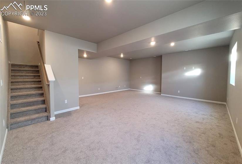 Spacious Family room and game area boasting 9' ceilings and prepped for a future wet bar!