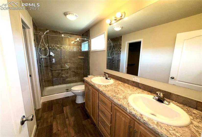 Master bath with double sinks and free standing showier