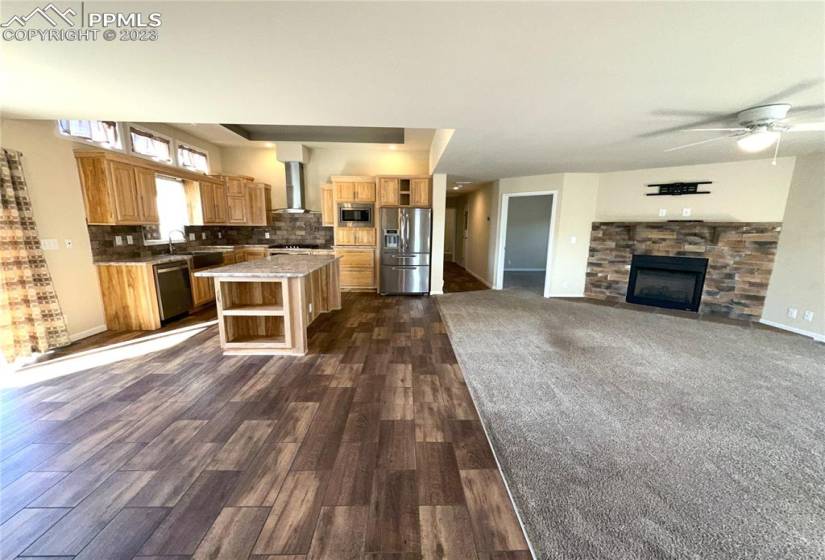 Open concept with wood flooring & carpet