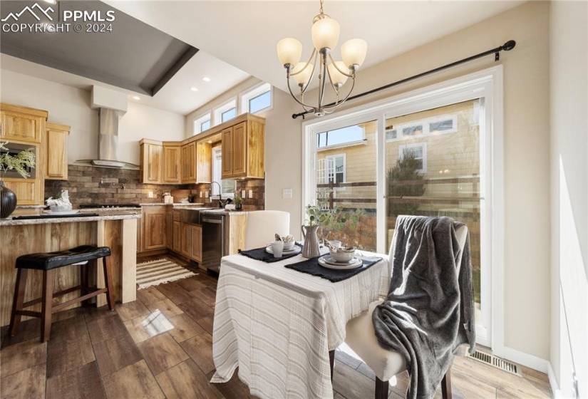 The Dining Area has a modern light fixture and slider to the backyard.