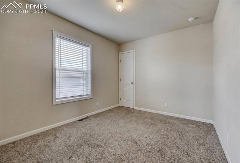 Bedroom #3 has neutral carpet and a walk in closet