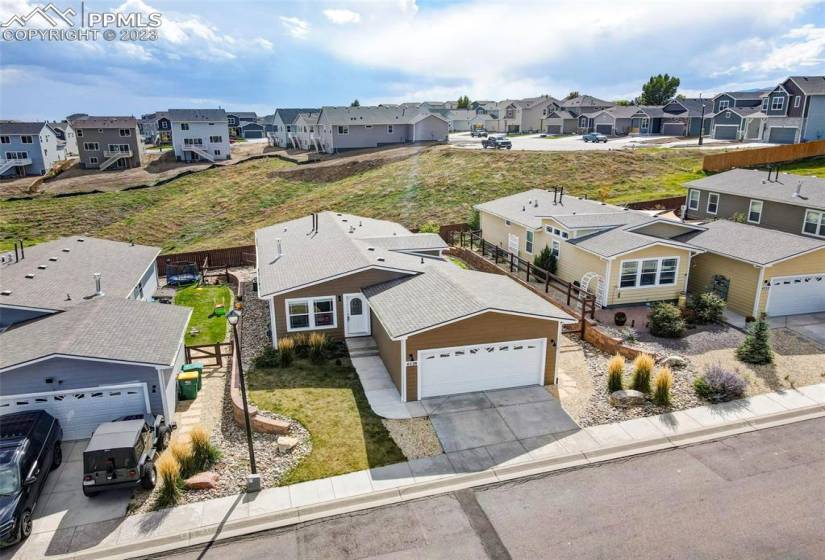 Aerial view of home and open green space behind the backyard fence