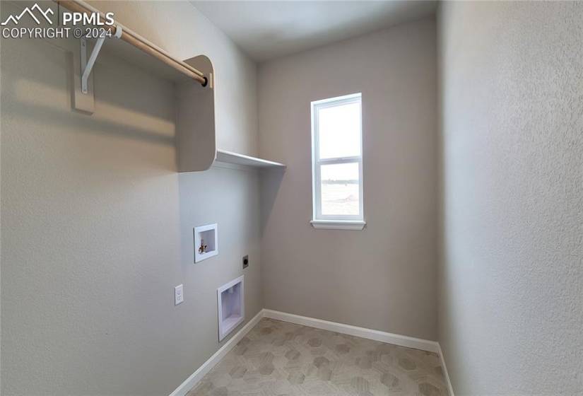 Laundry room with a window, conveniently located on the upper level!