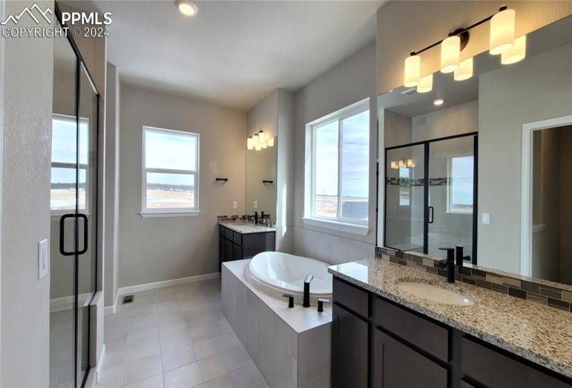 Plush 5-piece Bathroom with separate vanities, soaking tub, linen closet, and shower with bench!