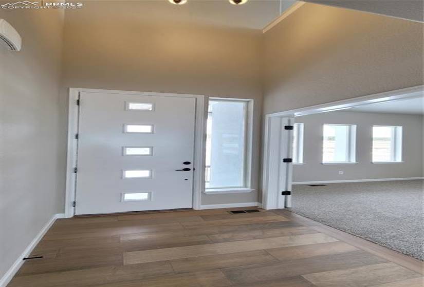Welcome Home! Enter through an 8' Front Door, engineered wood flooring and coat closet.