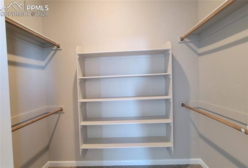 Primary closet with wood shelving and rods!