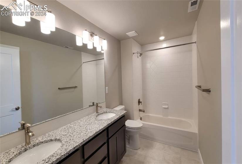 Full Bathroom with double vanities; granite countertop and tile surrounds, and a linen closet!