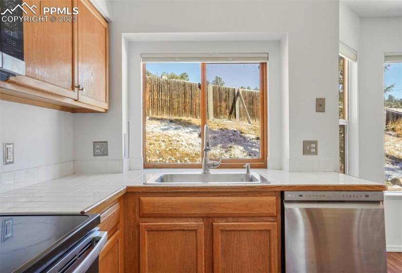 Bright, cheery kitchen that opens to the rest of the home and provides a vieew to the backyard