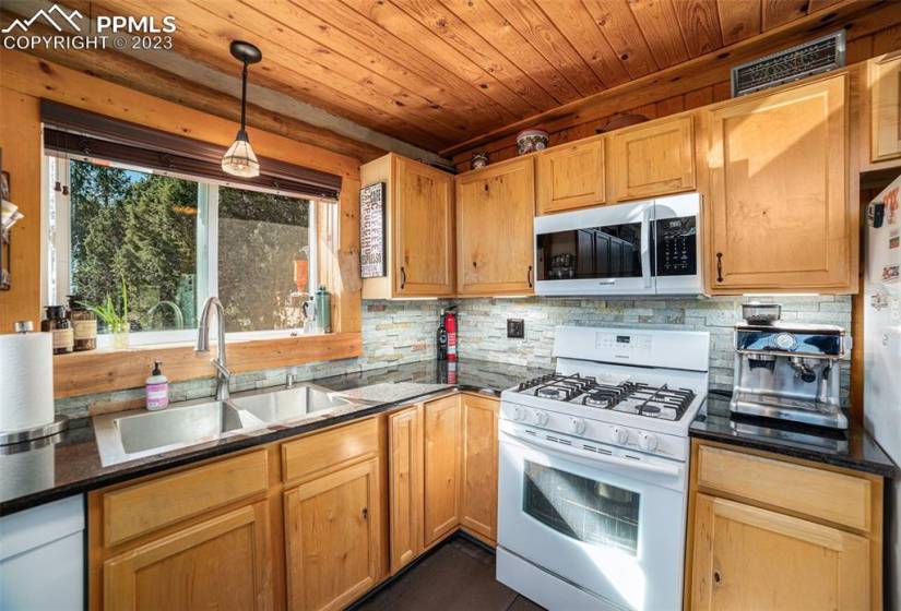 Large U Shaped kitchen with granite countertops