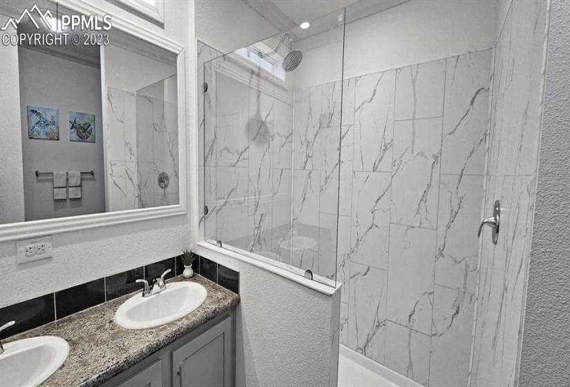 Elegant, open, walk-in shower and dual sinks