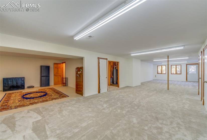Basement featuring gas water heater and light colored carpet