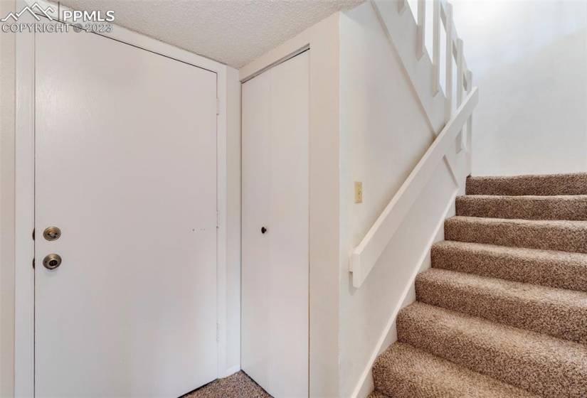 Lower level entrance/exit with stairs up to main level. Extra storage under stairs.