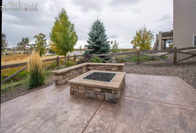 Gather around the gas fire pit seating area and enjoy the warmth of the flames complemented by stamped concrete under your feet. Low maintenance artificial grass adds to the allure, ensuring your outdoor space is always ready for enjoyment or entertaining.