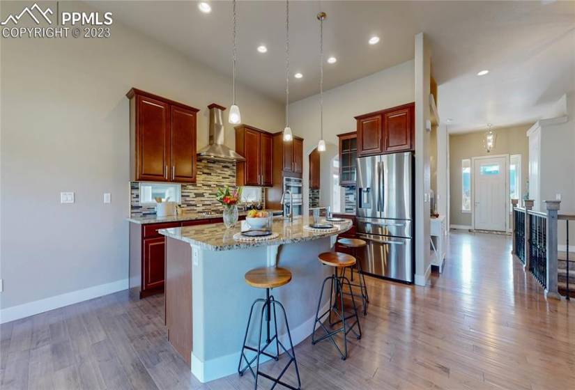Large kitchen island with gorgeous granite counters.