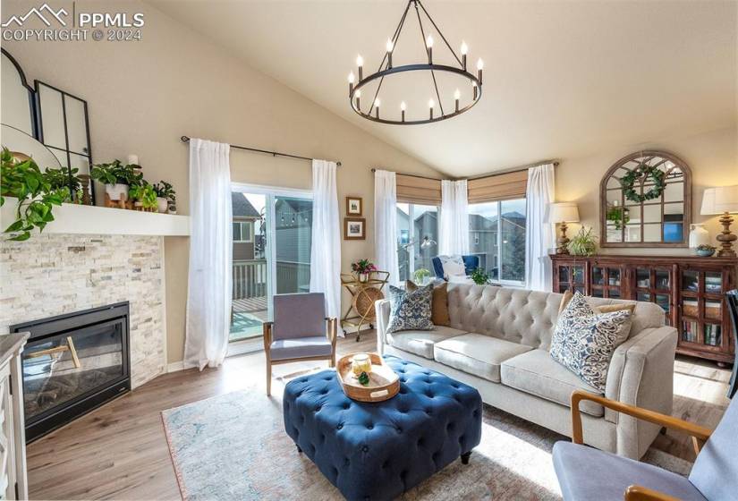 Relax in the connected living room w/ continued LVP, cozy gas fireplace w/ new stone, updated lighting & sitting space w/ mountain view.