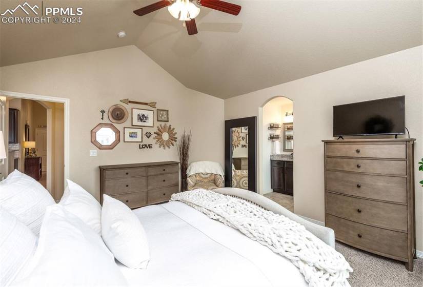 Main level primary bedroom has vaulted ceilings, en suite, and new custom closet system.