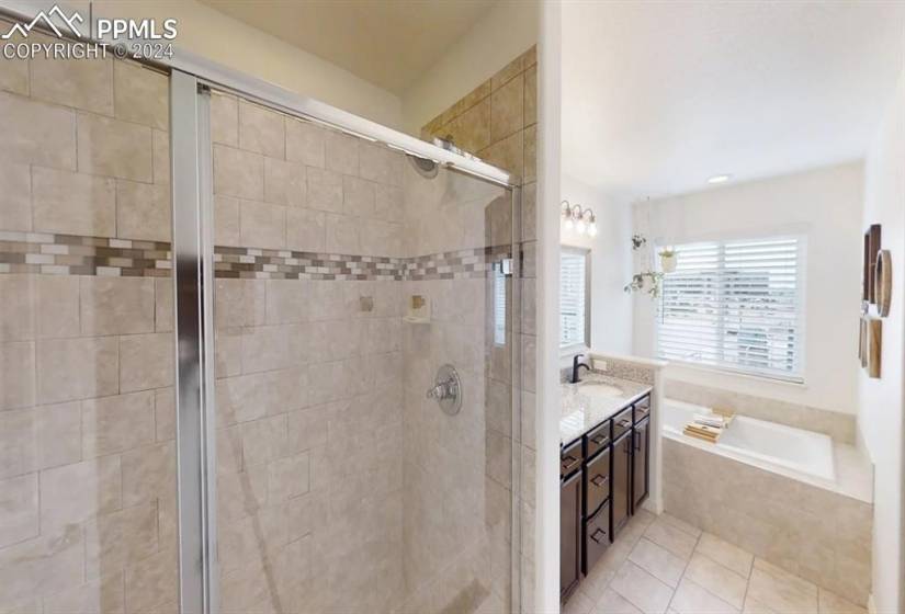 Walking shower with beautiful tile and glass door.