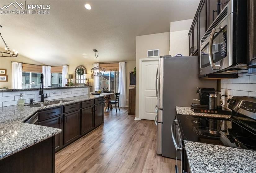 Beatuifully updated kitchen w/ 42” cabinets, granite and updated backsplash.