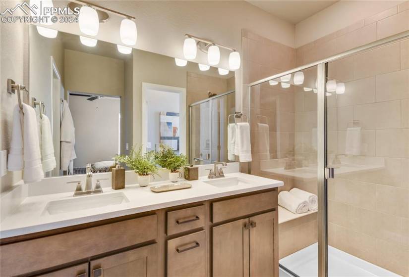 En-suite 4-piece bath with dual sinks, quartz counters, and walk-in shower