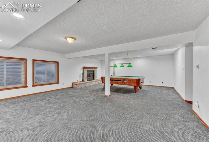 Large Basement Rec Room with wood fireplace and pool table that stays