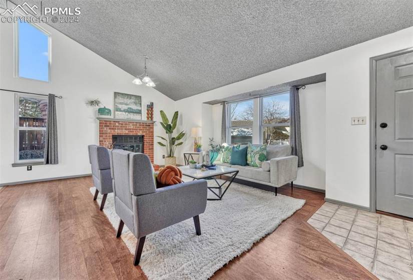 The Entry has a tile floor and coat closet for guests. It leads into a spacious vaulted Living Room with large view window for lots of natural light.