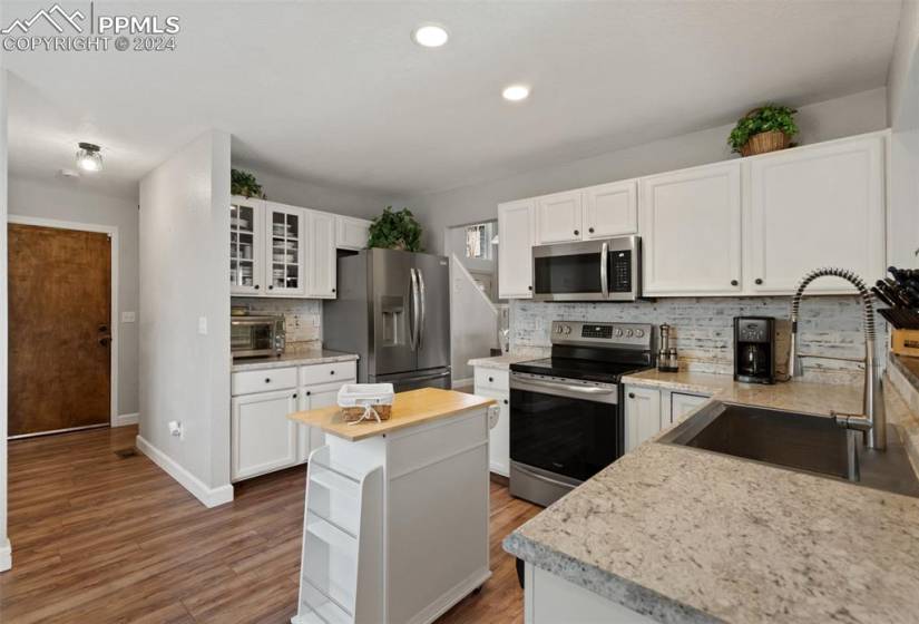 Charming Kitchen features new stainless appliances.