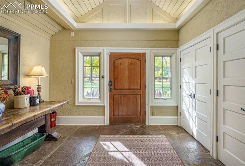 Stone Entryway with large built-in coast closets