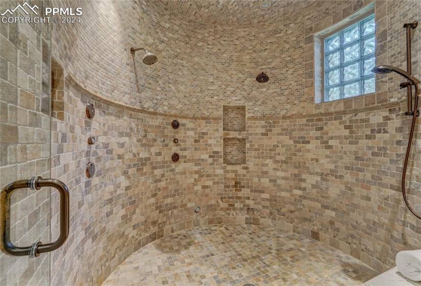 Primary bath with Fully enclosed steam shower with 4 heads including a Raindance on ceiling along with jets
