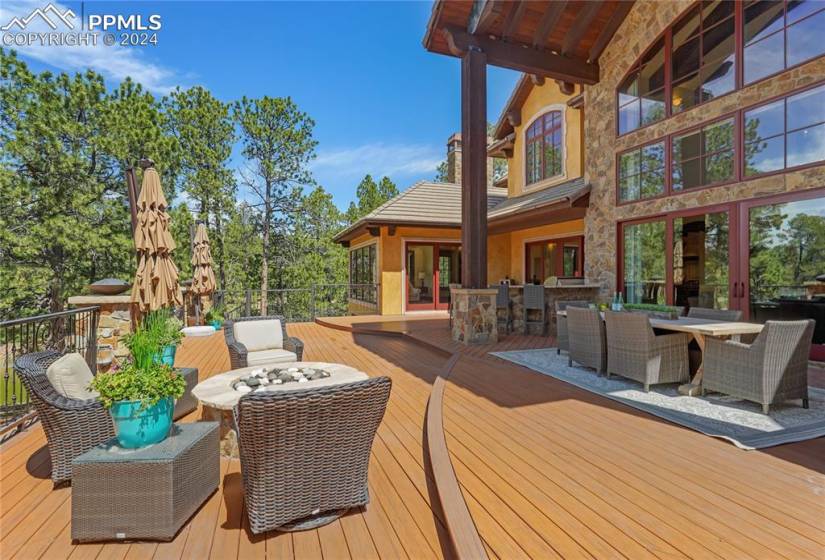 The spacious deck has plenty of room to entertain and enjoy stunning mountain views! A fabulous gas firepit and outdoor kitchen are delightful!