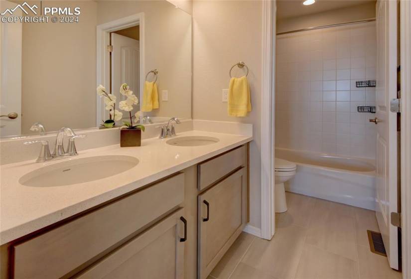 double vanity secondary bathroom located on the upper level