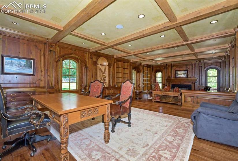 Home office featuring coffered ceiling, plenty of natural light, and wood-type flooring
