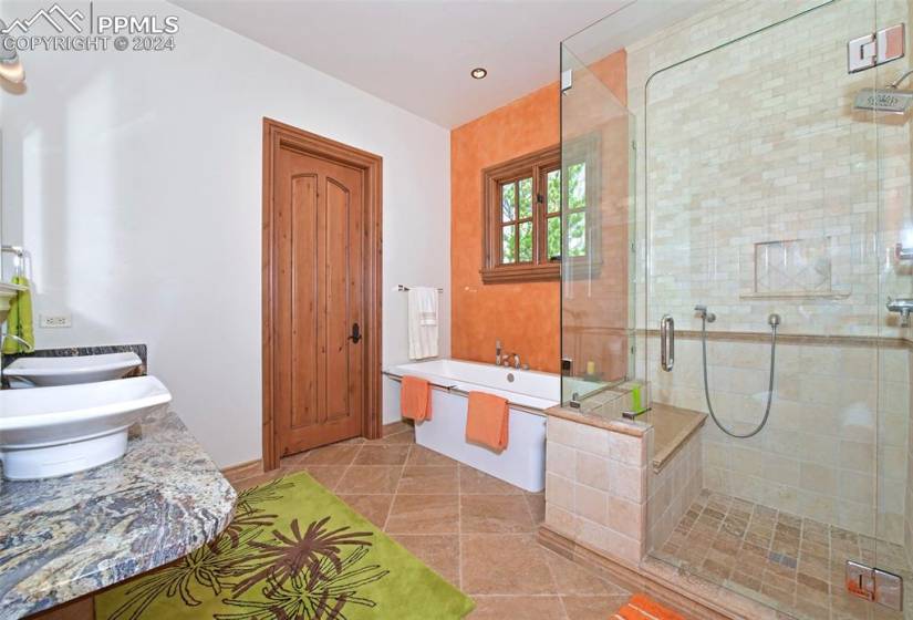 Bathroom featuring vanity, tile floors, and independent shower and bath