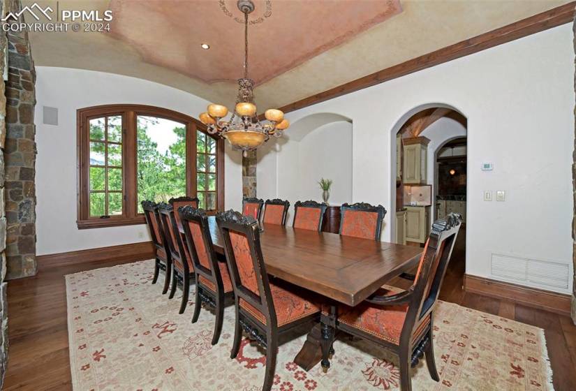 Dining room featuring dark hardwood / wood-style flooring and a notable chandelier