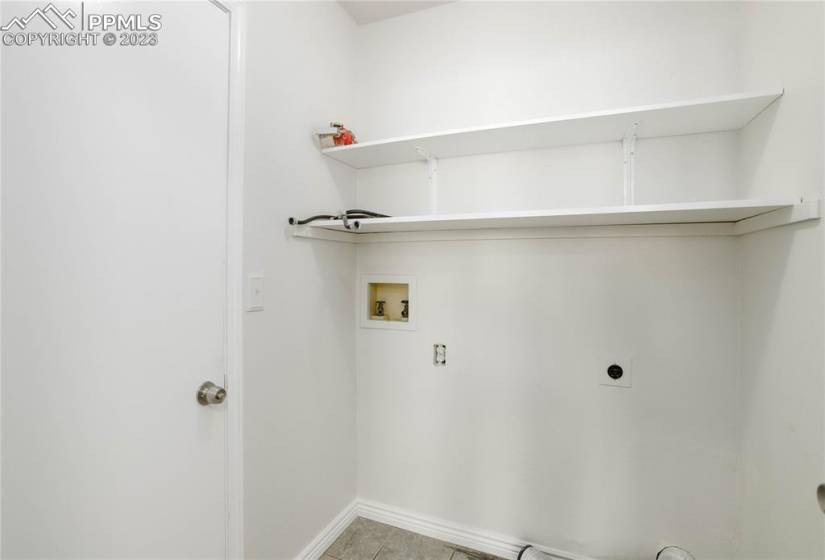 Laundry room with built-in shelving