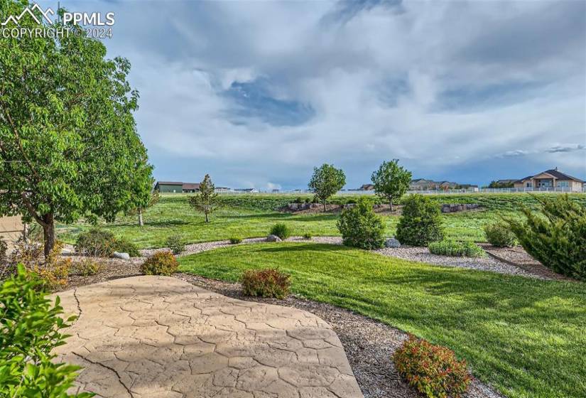 Stamped concrete patio and immaculately manicured backyard.
