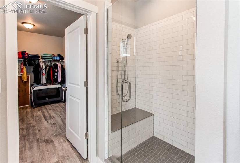 Bathroom featuring hardwood / wood-style floors and walk in shower
