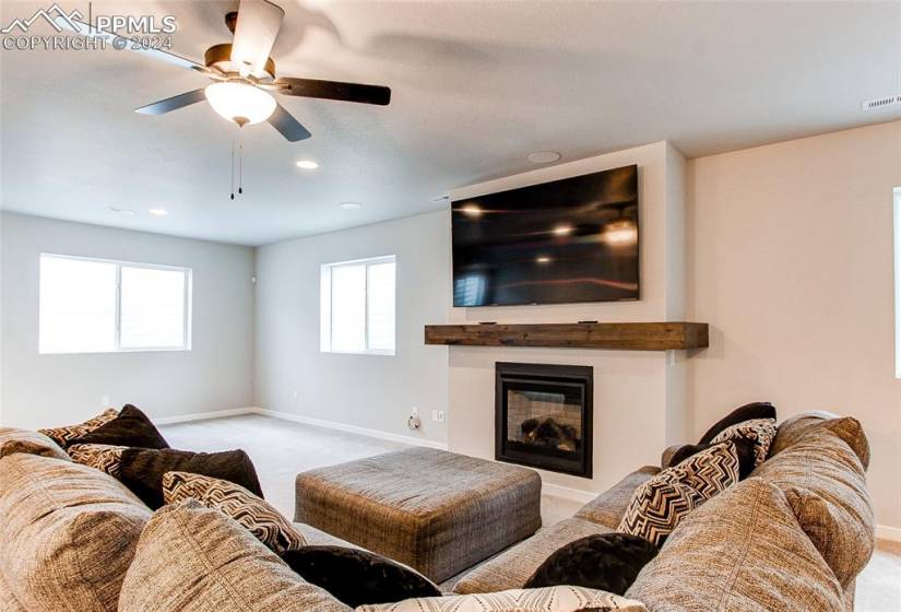 Living room featuring ceiling fan and light carpet