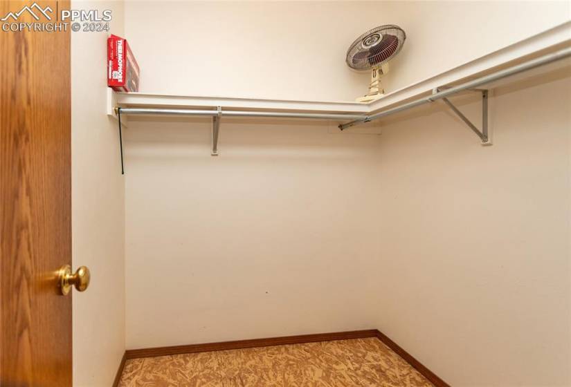 View of spacious closet with cedar flooring.