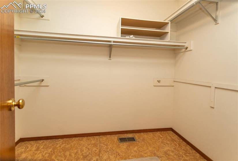 Spacious closet featuring cedar flooring