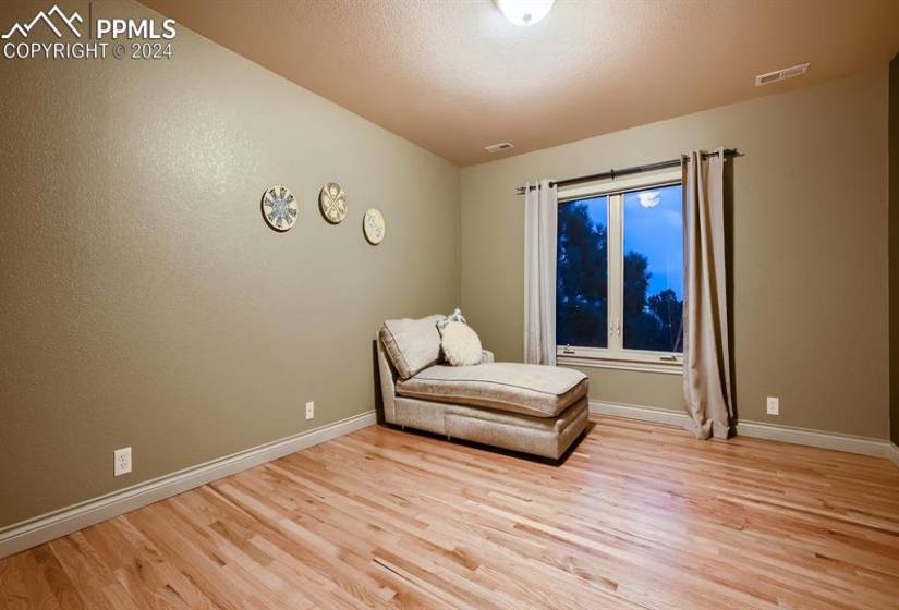 Second floor bedroom room with light wood flooring