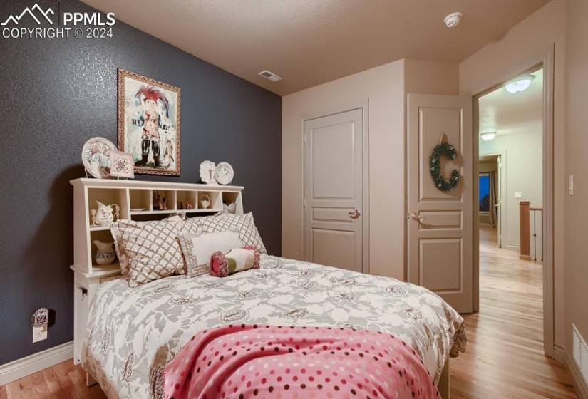 Bedroom with light hardwood floors and a closet