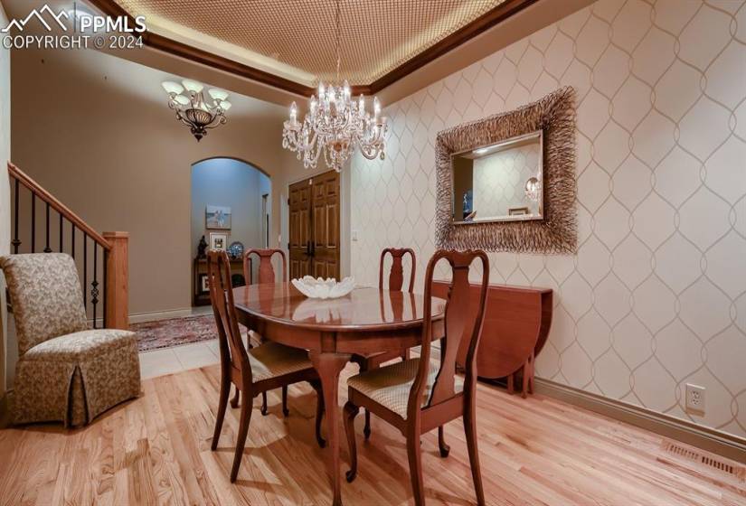 Dining area featuring light hardwood floors, facing entry and office
