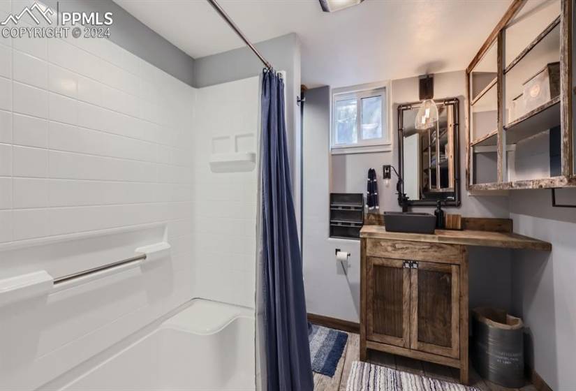 Bathroom with vanity, wood-style flooring, walk-in shower, lots of storage in bathroom