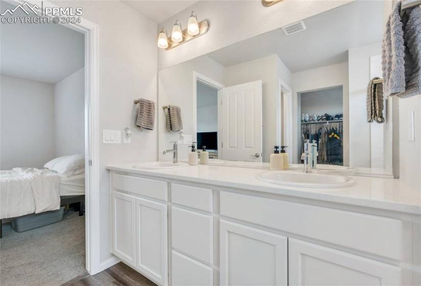 Bathroom with hardwood / wood-style floors and double vanity