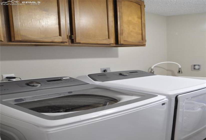 Laundry Room offers cabinetry for storage and new laundry sink